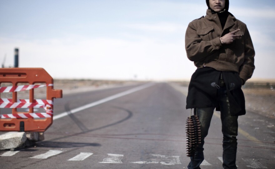 A lone rebel mans the last checkpoint before the flashpoint Libyan town of Ras Lanuf on Saturday.