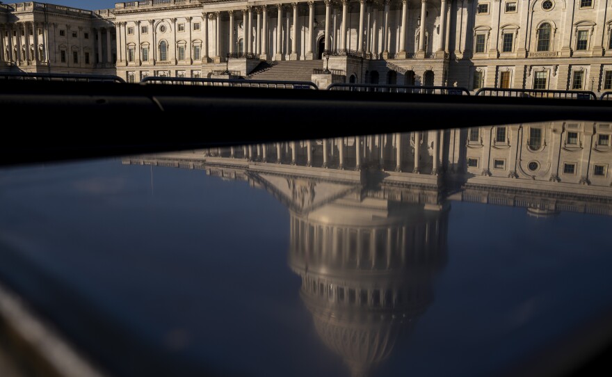 The dome of the U.S. Capitol building is visible in a reflection on Capitol Hill in Washington, D.C., Jan. 23, 2023.