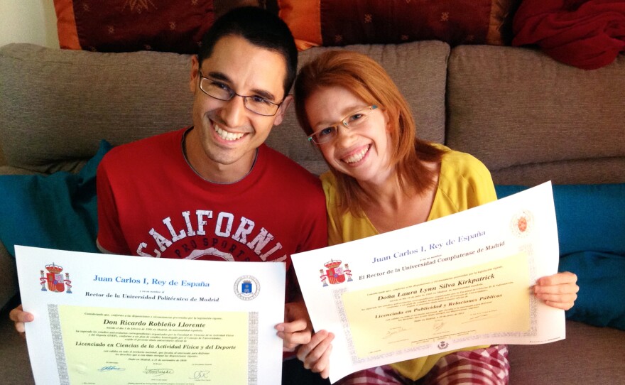 Ricardo Robleño Llorente and his wife Laura Silva Kirkpatrick show their college degrees at home in Madrid. Even though they have two bachelor's degrees and a master's between them, they were unable to find permanent work through most of their 20s, during Spain's economic crisis. Now 30, they have temp jobs. "Why bother going to college at all?" asks Silva Kirkpatrick.