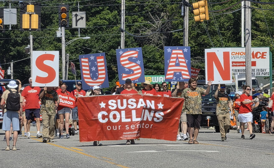 At the annual Moxie Day Parade in Lisbon, Maine, supporters of Sen. Susan Collins, R-Maine, march with signs and giant letters spelling S-U-S-A-N, on July 11.
