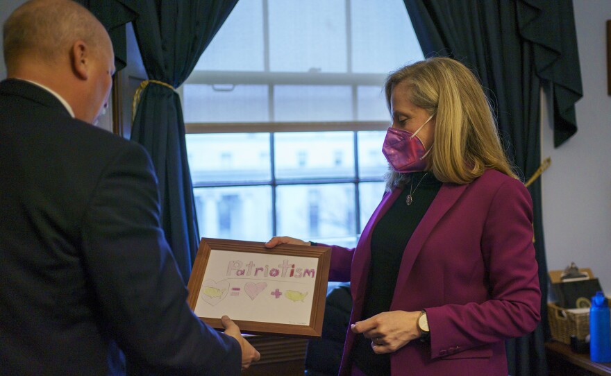 Spanberger shows Roy a framed picture in her office. Both lawmakers bemoan that in the current political environment there is a tendency to avoid signing onto bills without 100% agreement on every detail.