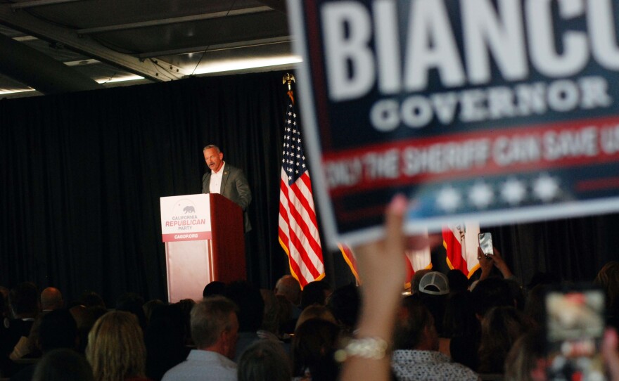 The image shows Chad Bianco, candidate for California Governor, appearing at the California Republican Party convention in San Diego on April 11, 2026.