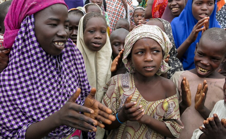 They're not in class, so to while away the time Maimuna Bundi, second from right, sings with her friends at Muna camp.