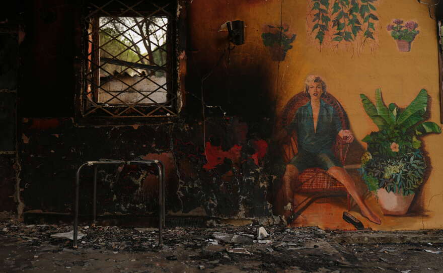 A campsite's bungalows are charred after it was ravaged by a wildfire in Pelayos de la Presa, Madrid province, Spain, Monday, July 27, 2026.