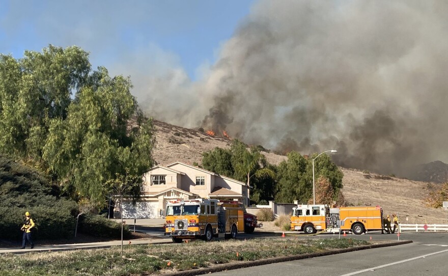 Flames are seen on the hillside in Santee at the Chaparral Fire on Dec. 16, 2020.