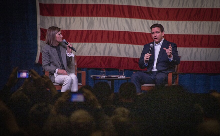 Florida Gov. Ron DeSantis talks with Iowa Governor Kim Reynolds during a trip to Davenport, Iowa, on March 10, 2023, while he mulls a run for president in 2024.