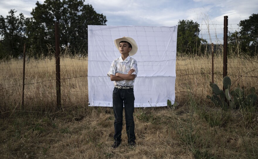 Carlitos, Kevin's youngest brother, poses for a portrait at Kevin's birthday party in June 2023.