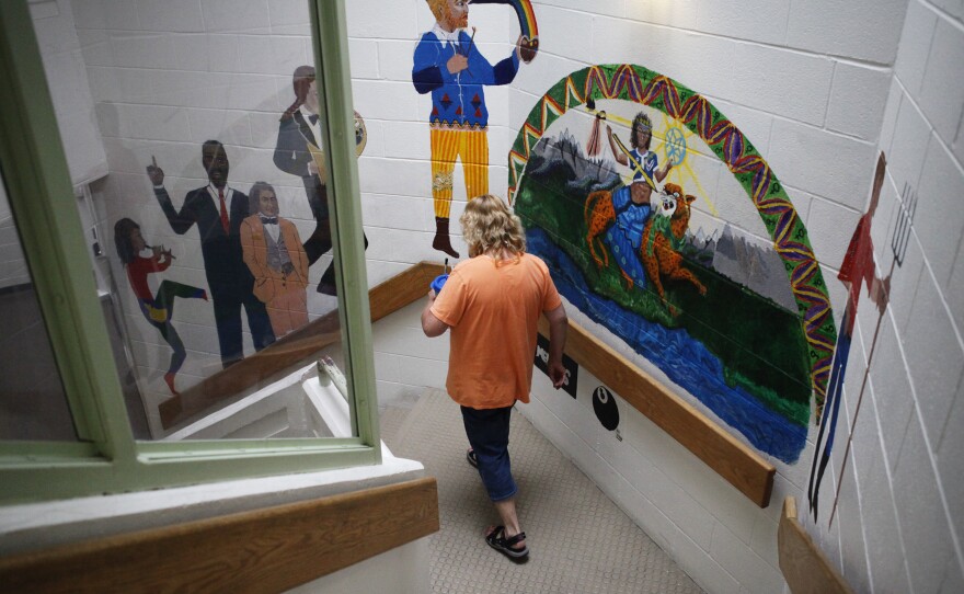 Elder walks downstairs to the residential area of the facility.