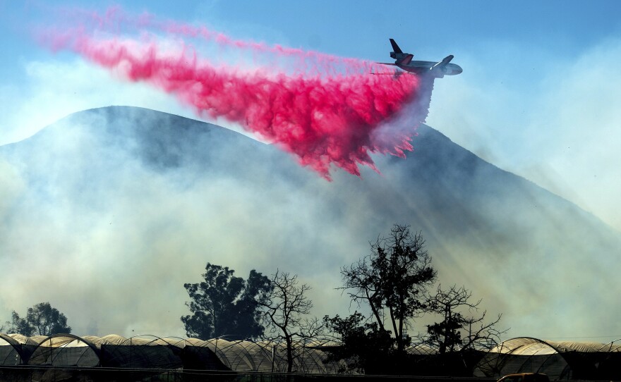 An air tanker drops retardant as the Maria Fire approaches Santa Paula, Calif., on Friday.