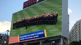 An image of The San Diego Gay Men's Chorus on the jumbo tron at Petco Park as they prepare to sing the National Anthem on May 21, 2016. 