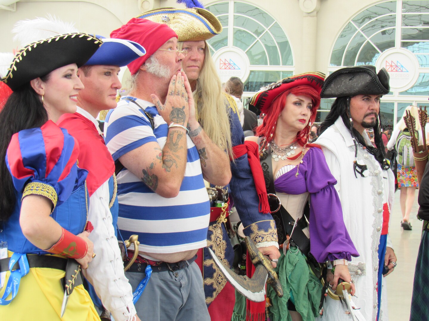 Comic-Con attendees dressed as Disney-inspired pirates pose in Sails Pavilion at the San Diego Convention Center on July 25, 2025.