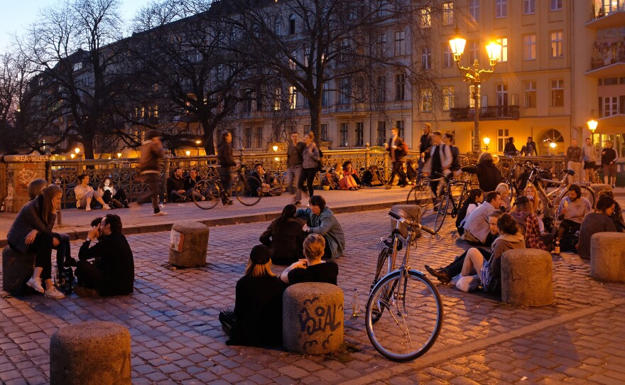 People relax on a bridge in Berlin. An estimated 10,000 Israelis have moved to the German capital in the past decade or so, leaving an imprint on the city of more than 3.5 million.
