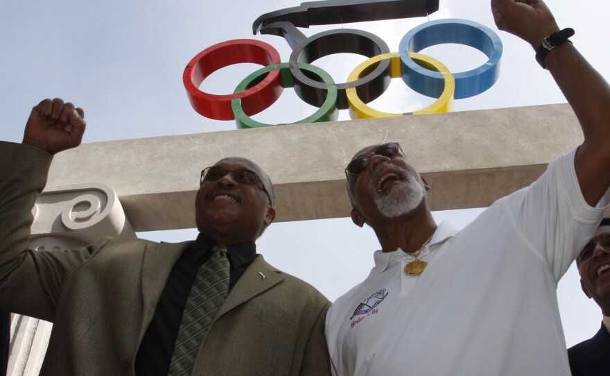 Smith (left) and Carlos hold up their fists at the Mexican Olympic Committee building in Mexico City on Oct. 15, 2008.