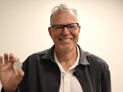 Artist Christopher Polentz holds a coin featuring his design on Thursday, June 4, 2026.