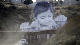 A Border Patrol vehicle drives in front of a mural in Tecate, Mexico, just beyond a border structure in Tecate, Calif. Friday, Sept. 8, 2017. 