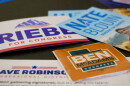 Candidate handouts are displayed at an event for candidates running to represent Utah's new Democratic-leaning congressional district in Taylorsville, Utah on March 21. While some candidates have since dropped out, four remain including former Rep. Ben McAdams and state Sen. Nate Blouin.