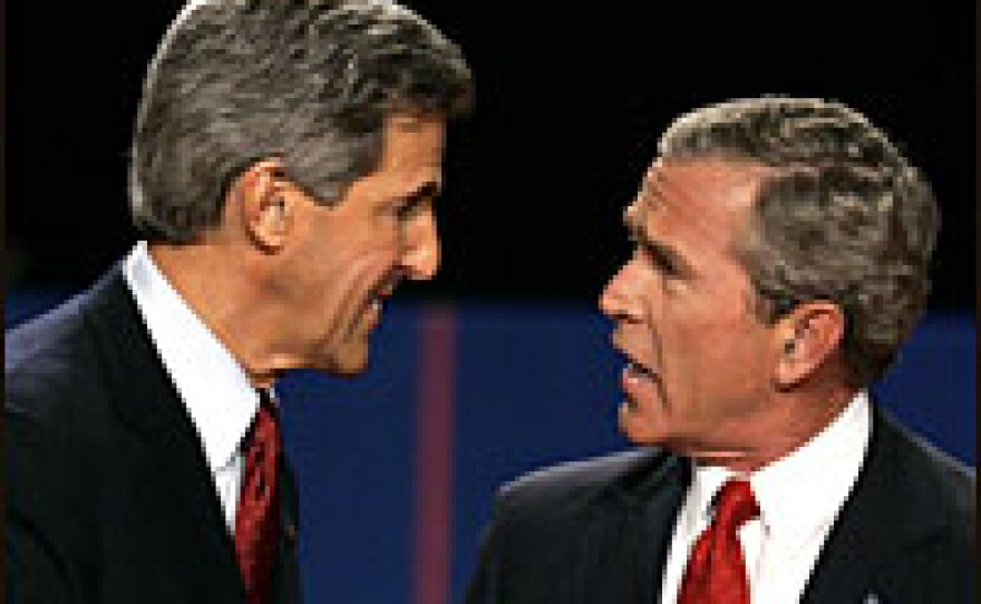 Democratic presidential nominee Sen. John Kerry and President George Bush talk on the stage after their final debate on Oct. 13.