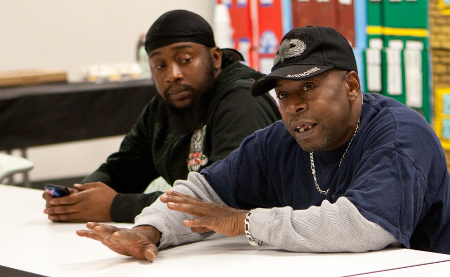 Harrelle Felipa, right, speaks during the Responsible Fathers meeting at the Center for Urban Families in Baltimore. His child support debt has accrued to $20,000 after he quit a job to be a stay-at-home dad.