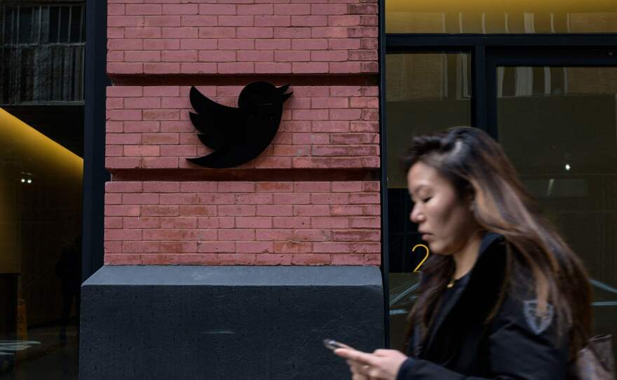 A person walks past the Twitter offices in New York City last week. Lawyers for Musk argued that public perception of the billionaire's Twitter takeover has tainted the potential jury pool.