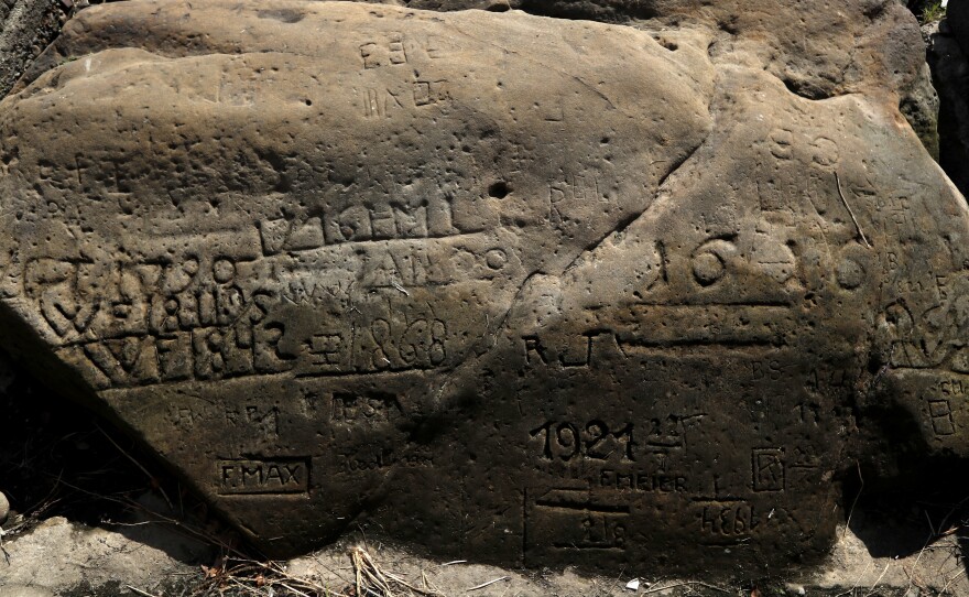 A "hunger stone" exposed by the low level of water in the Elbe river is seen in Decin, Czech Republic, on Thursday. The low level of water caused by the recent drought has exposed the stones on the river bed.