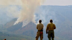 Firefighters watch a controlled burn within the Grizzly Creek Fire in Colorado in this undated photo. The fire has burned more than 30,000 acres near Glenwood Canyon. Now, the charred hillsides pose a flood risk for nearby areas.