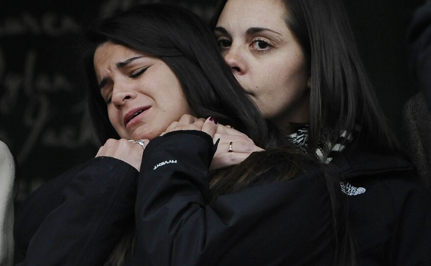 Erica Lafferty, daughter of Sandy Hook Elementary School shooting victim, Dawn Hochsprung, right, consoles Carlee Soto, sister of victim Victoria Soto after families representing fourteen families addressed the media, on Monday in Newtown, Conn.