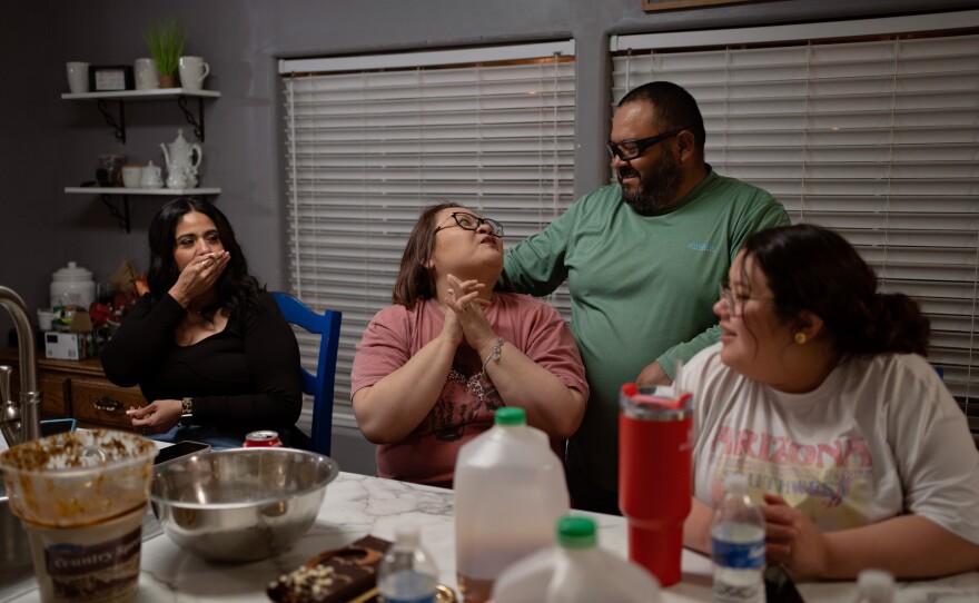 Cindy Almance (center left) and her husband Eddie (center right) talk as their daughter Caitlynn looks on. Cindy and Eddie have been married for 23 years.
