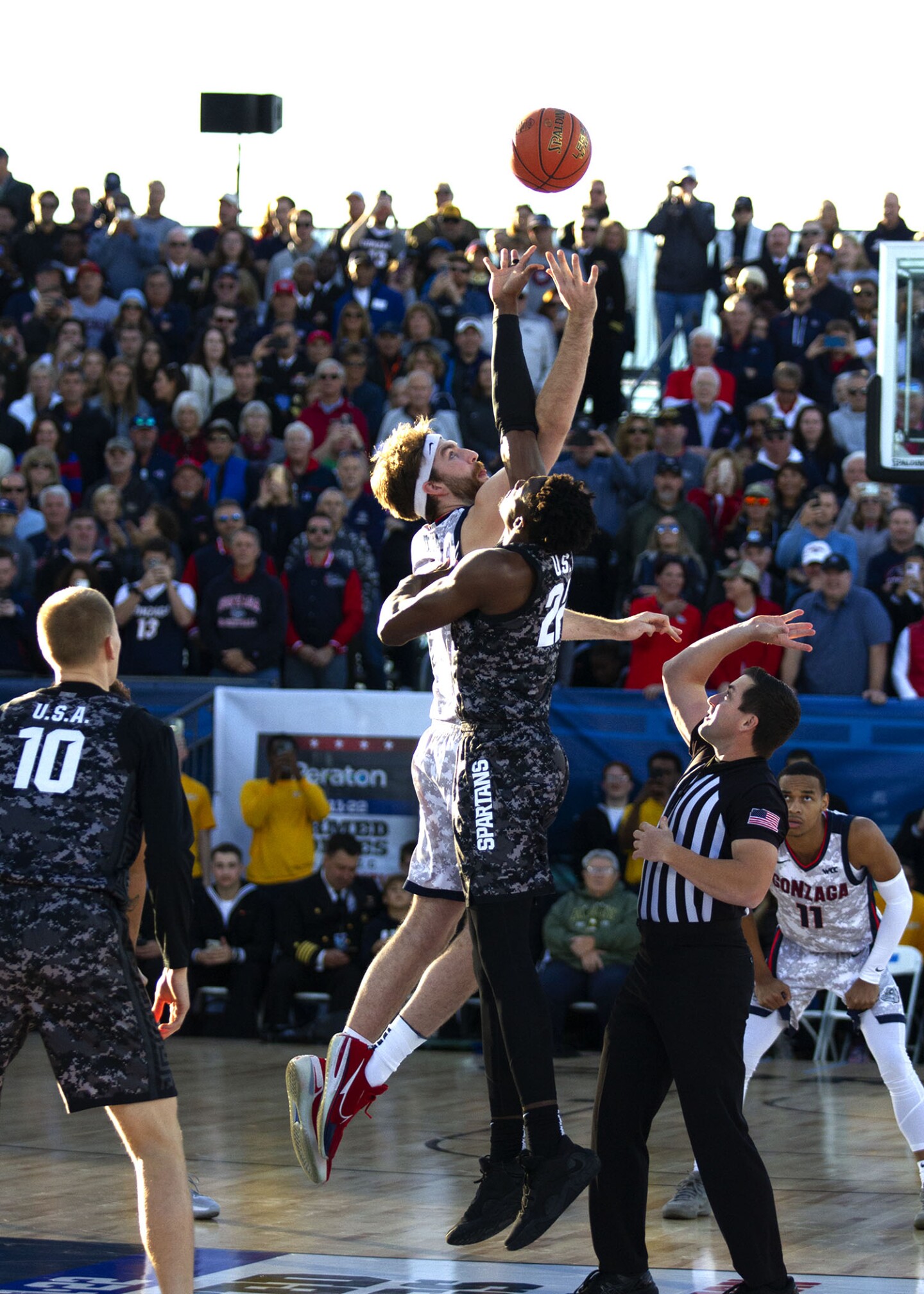 MSU and Gonzaga players tip off as the sun sets aboard USS Abraham Lincoln while in port at Naval Air Station North Island on Nov. 11, 2022.