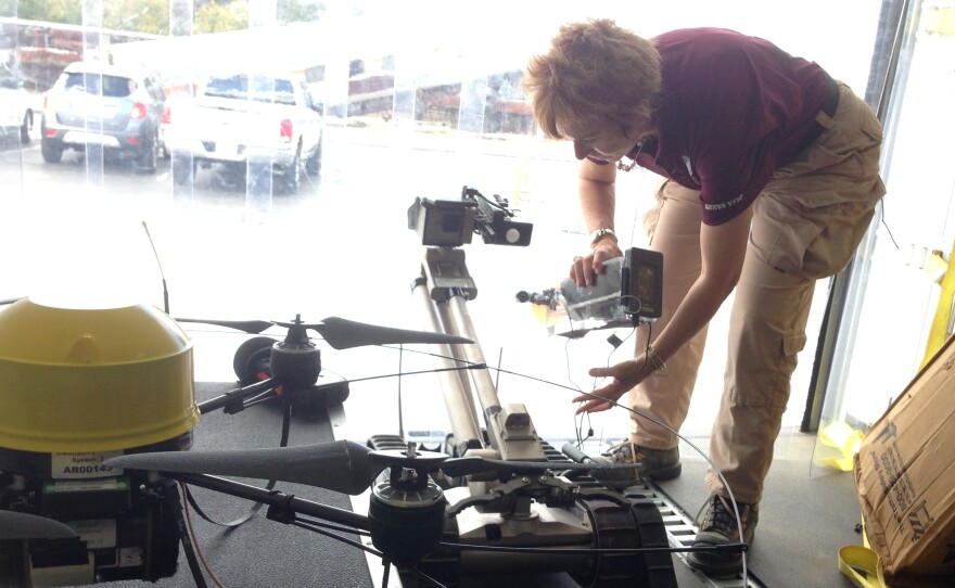 Robin Murphy, director of the Center for Robot-Assisted Search and Rescue at Texas A&M University, adjusts a robot used in hazardous waste cleanup.