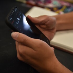 Sage Creek High School student holds cell phone in class. Carlsbad, Calif. Aug. 29, 2024
