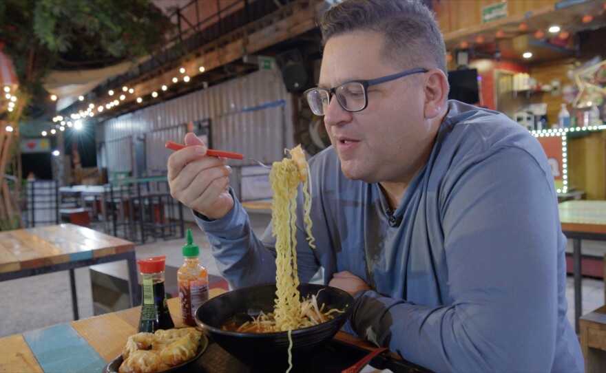 Host Jorge Meraz enjoys the asian ramen soup available at the Tijuana Gastro Cinema Park