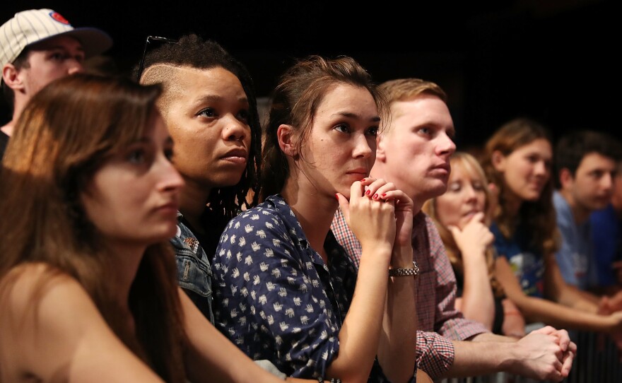 People listen during an event that featured DNC Chair Tom Perez and Sen. Bernie Sanders during their "Come Together and Fight Back" tour at the James L Knight Center on Wednesday in Miami, Fla.