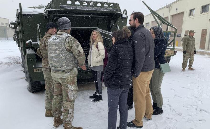 Discover Canyon High School Counselor Staci Wayant (center) joins other Colorado teachers on a tour of military vehicles on Fort Carson in this undated photo.