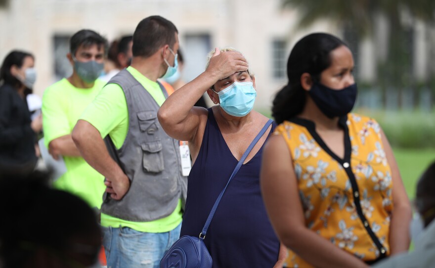 Carmen Garcia waits in line Friday to be tested for the coronavirus at a mobile testing truck in Miami Beach, Fla. The units were brought to the area as coronavirus cases spike in Florida.