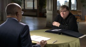 Host Henry Louis Gates, Jr. with filmmaker Michael Moore while taping FINDING YOUR ROOTS.