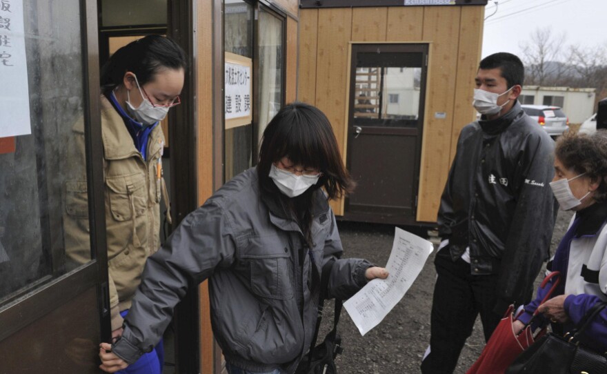 Evacuees who lost their homes in the March 11 earthquake and tsunami visit a makeshift city hall to apply for temporary housing in Rikuzentakata, Japan.