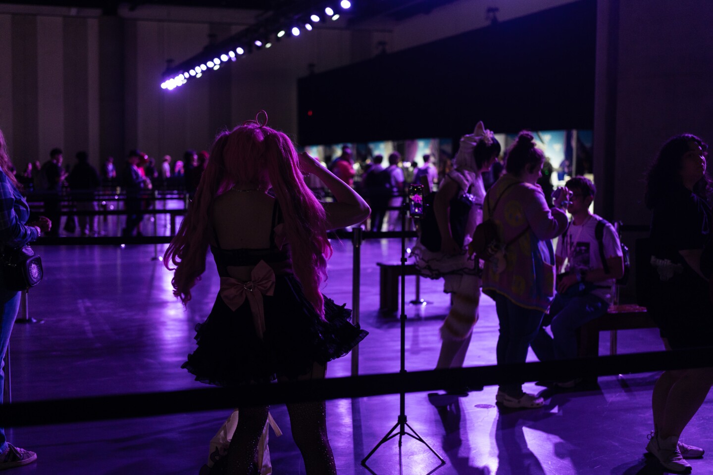 A convention attendees streams while waiting in line for a meet and greet with the popular vtuber, Ironmouse, at TwitchCon San Diego on Oct. 17, 2025. A vtuber, or virtual YouTuber, uses a digital avatar to create content on Twitch.
