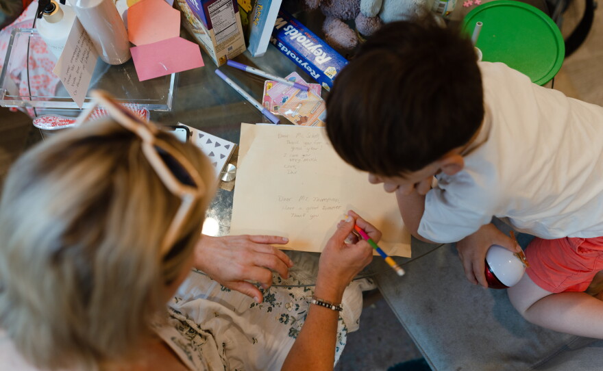 Dani Bensky sits at her kitchen table with her 6-year-old son in New Jersey on June 22. Together, they write notes to give to his teachers on the last day of school before summer break.