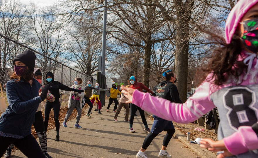 Michael Aredes teaches a Zumba class outside Prospect Park in  Brooklyn. About 10 women bundled up to join the socially distant exercise class on a recent Saturday.