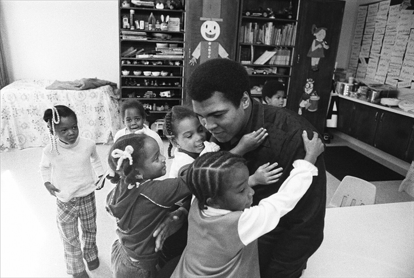 Muhammad Ali on a visit to his old grammar school surrounded by students. Louisville, Ky. Circa 1977.
