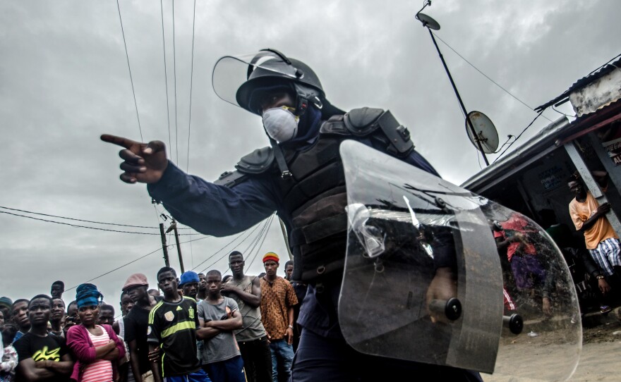 The military and the police enforce an Ebola quarantine in West Point, a densely populated slum in Monrovia, Liberia.