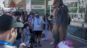 A cosplayer greets fans in a full Chewbacca suit at Comic-Con on July 25, 2025.