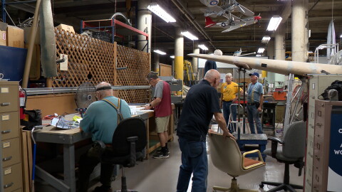 Volunteers are shown working on a replica of the Hughes H-1 Racer in the restoration shop of the San Diego Air & Space Museum on July 13, 2026.