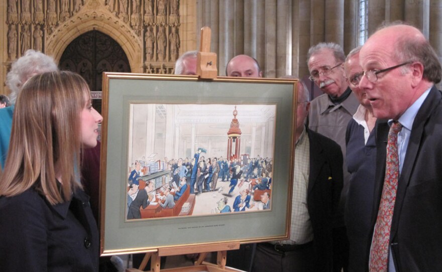 Paintings specialist Dendy Easton examines a Bateman cartoon.