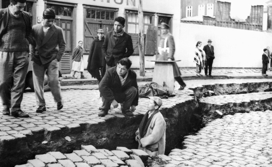 Residents of Valdivia, Chile, inspect an enormous crack caused by the Great Chilean Earthquake on May 22, 1960.