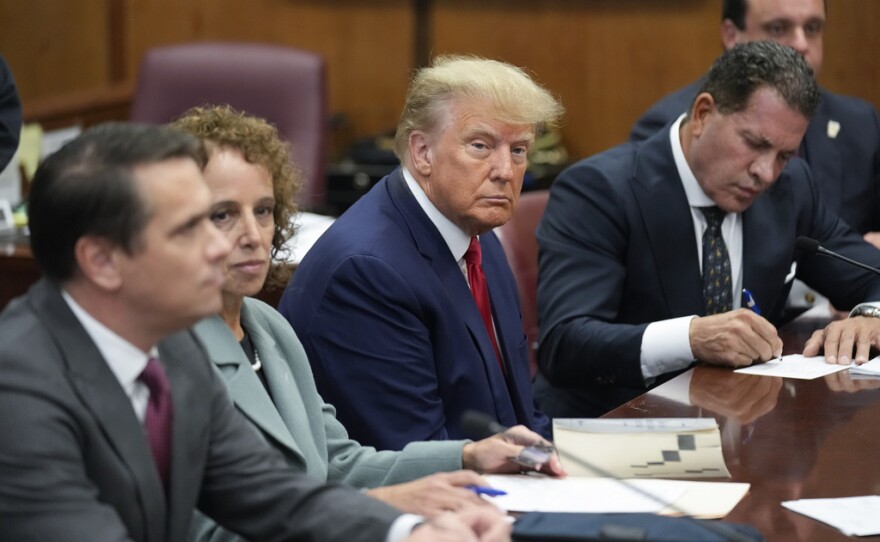 Former President Donald Trump sits at the defense table with his defense team in a Manhattan court, Tuesday, April 4, 2023, in New York. Trump is set to appear in a New York City courtroom on charges related to falsifying business records in a hush money investigation, the first president ever to be charged with a crime.