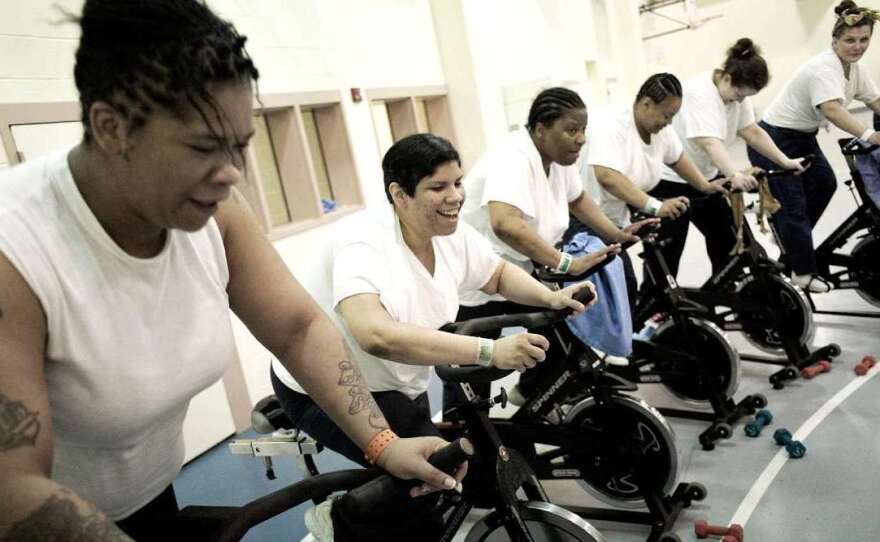 Women incarcerated at the Riverside Correctional Facility in Philadelphia take part in a spinning class run by Gearing Up. Amanda Cortes (second from left) lost 90 pounds in a year.