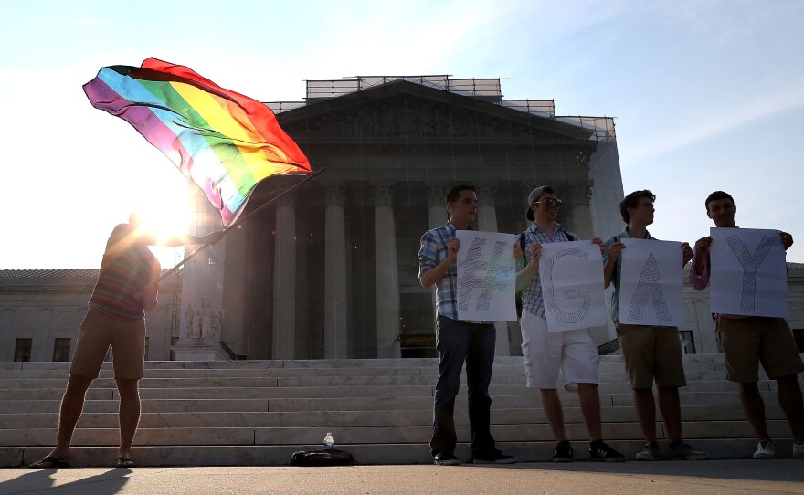 Gay rights activists gather in front of the Supreme Court building on Wednesday.