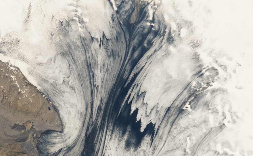 Glaciers and volcanoes frequently interact in Iceland — a relationship that's rare elsewhere on Earth. This satellite image from NASA shows a glacier in Iceland's Vatnajökull National Park, with volcanic ash embedded within it.