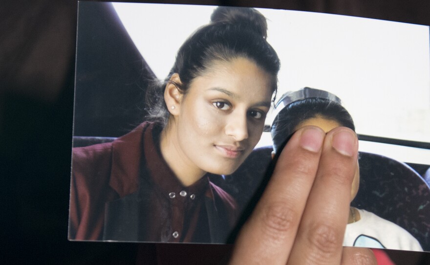 Renu Begum, eldest sister of Shamima Begum, holds her sister's photo as she is interviewed by the media at New Scotland Yard. The U.K. revoked Shamima Begum's British citizenship two years ago, citing security concerns.